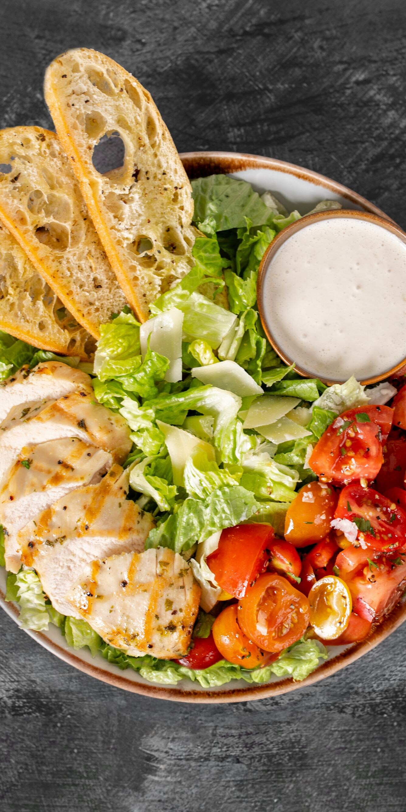 Top down photo of Caesar Salad on dark table
