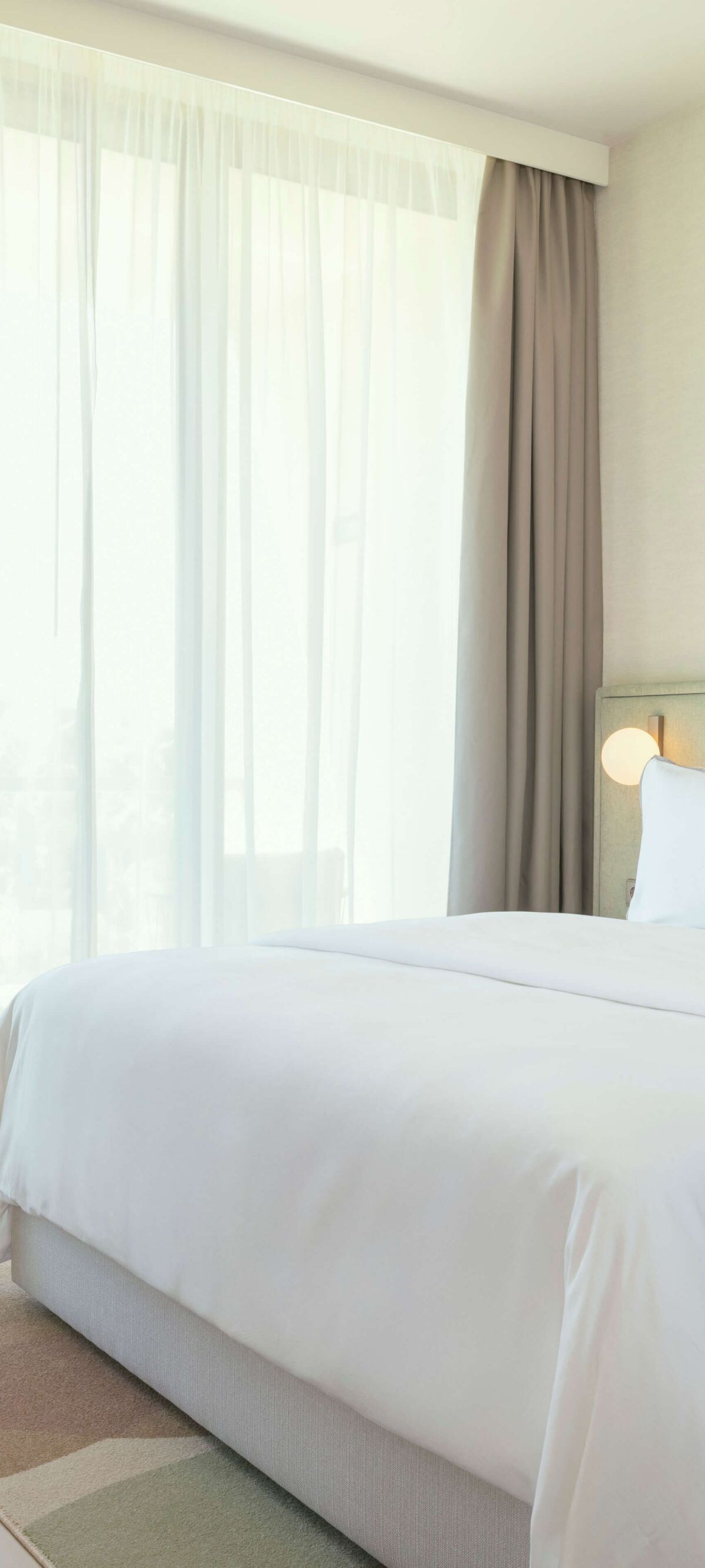 Bright hotel bedroom with king bed