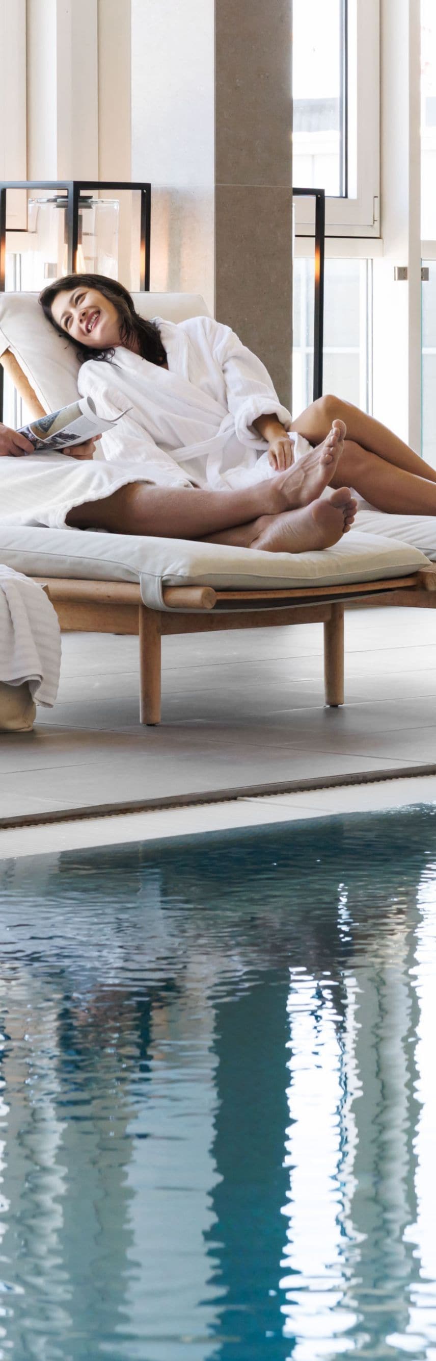 Guests seated beside the indoor pool