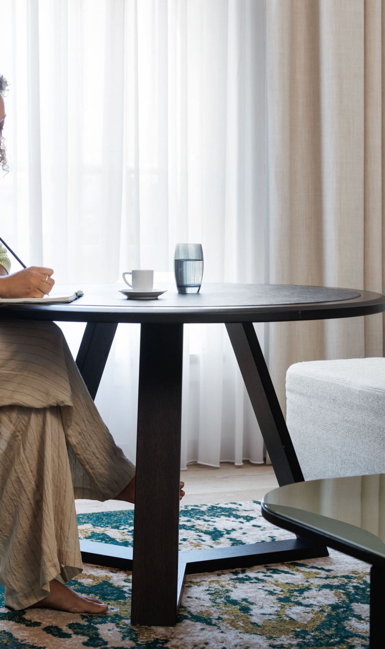 Guest writing at a table in the suite
