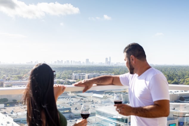 Couple standing at railing overlooking city view