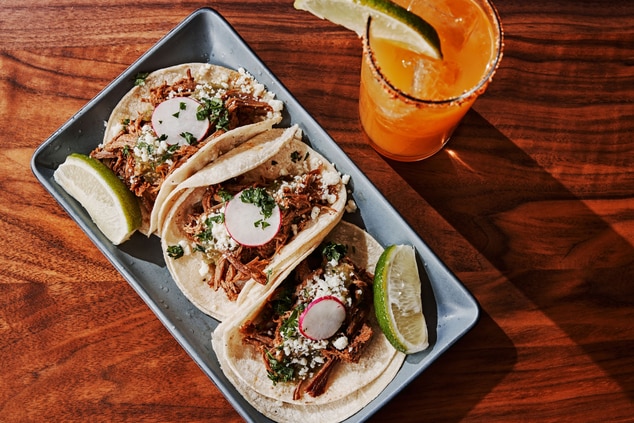 Tacos with lime wedge and cocktail