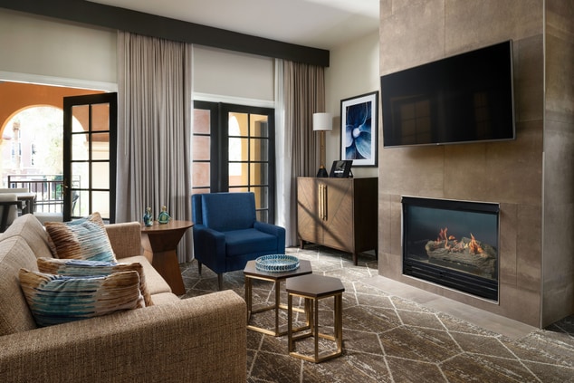 suite living room with couch and fireplace