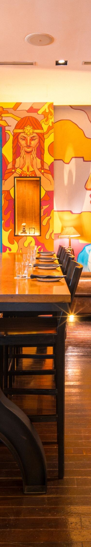 Restaurant dining space with mural