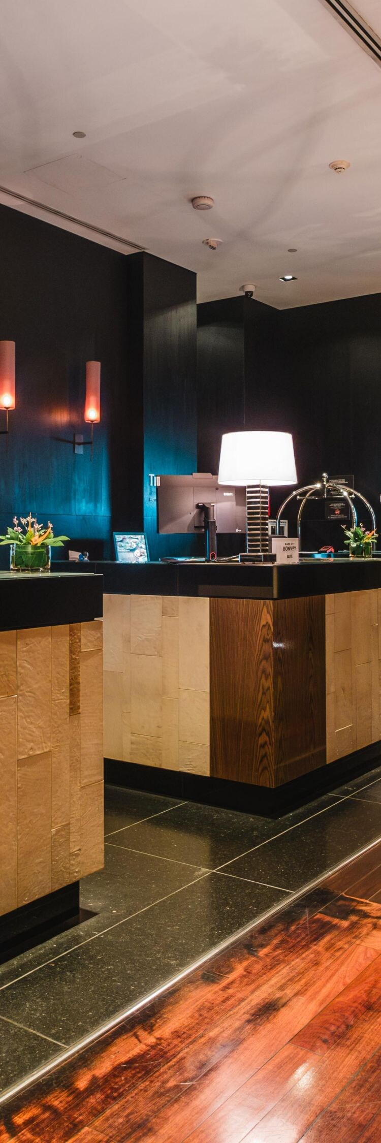 A modern lobby with dark colors and hardwoods.