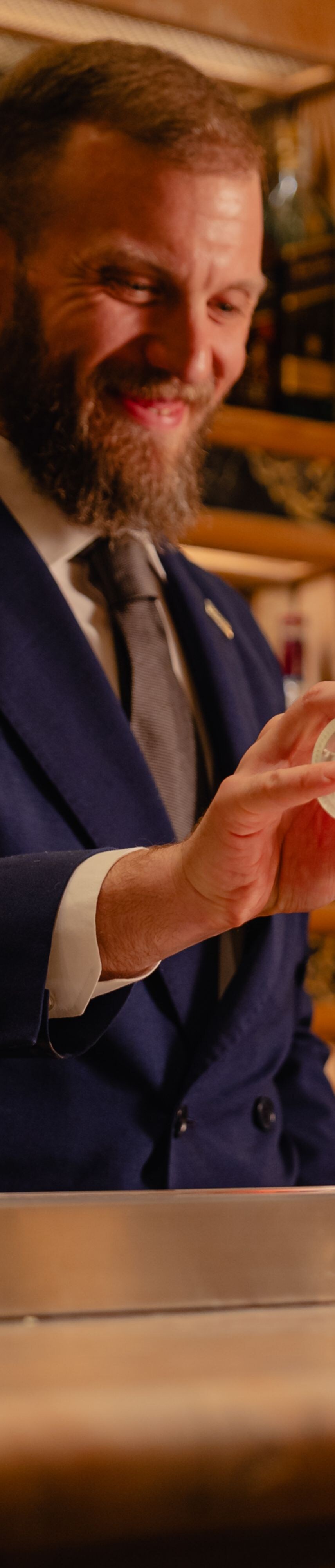 Barman pouring soda topping off cocktail