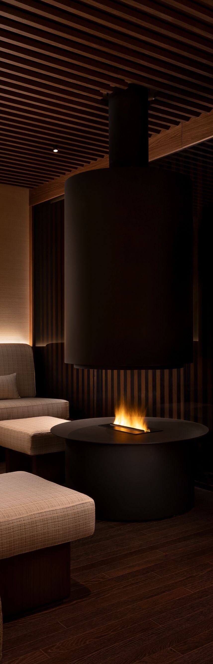 TèraSpa relax room with couches and lit fireplace