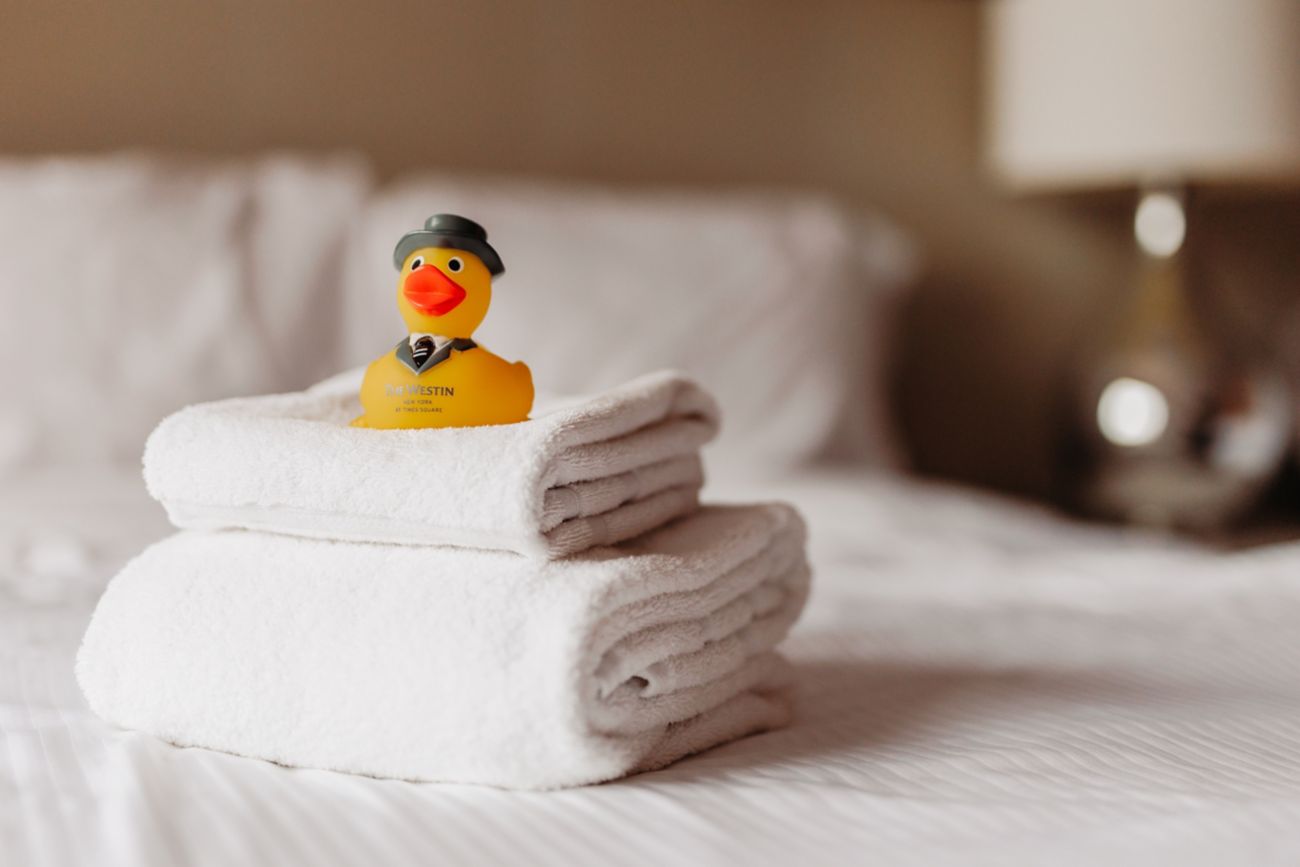 Towels and duck on bed