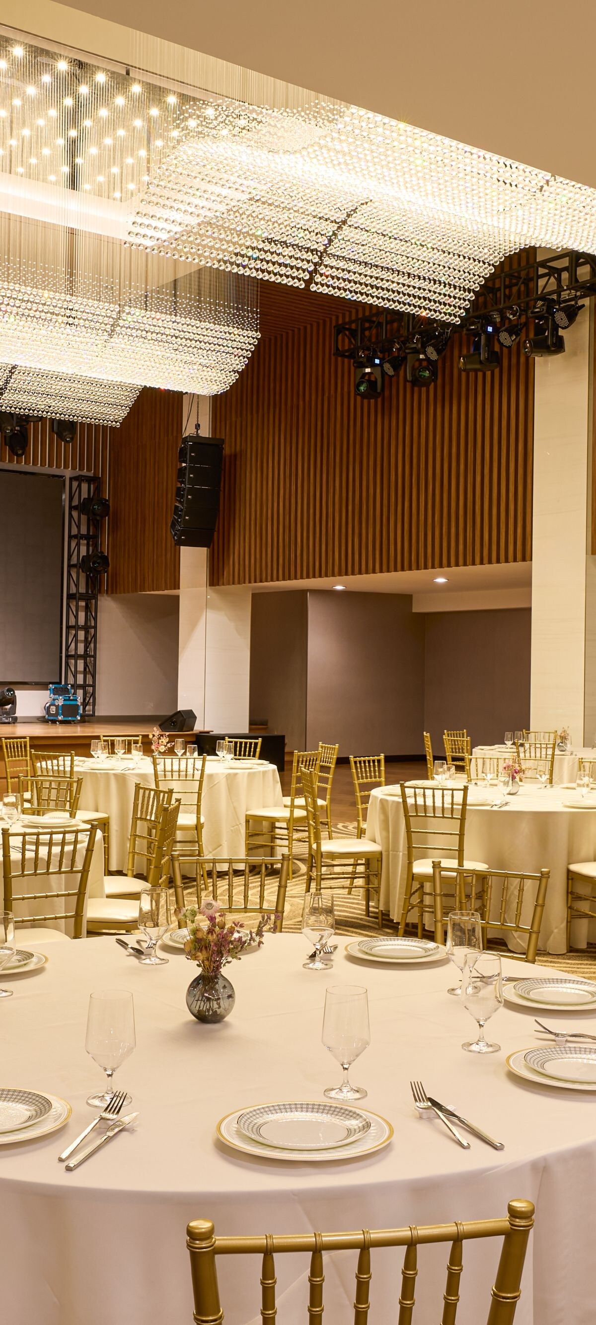 Elegant ballroom setup with stage and round tables