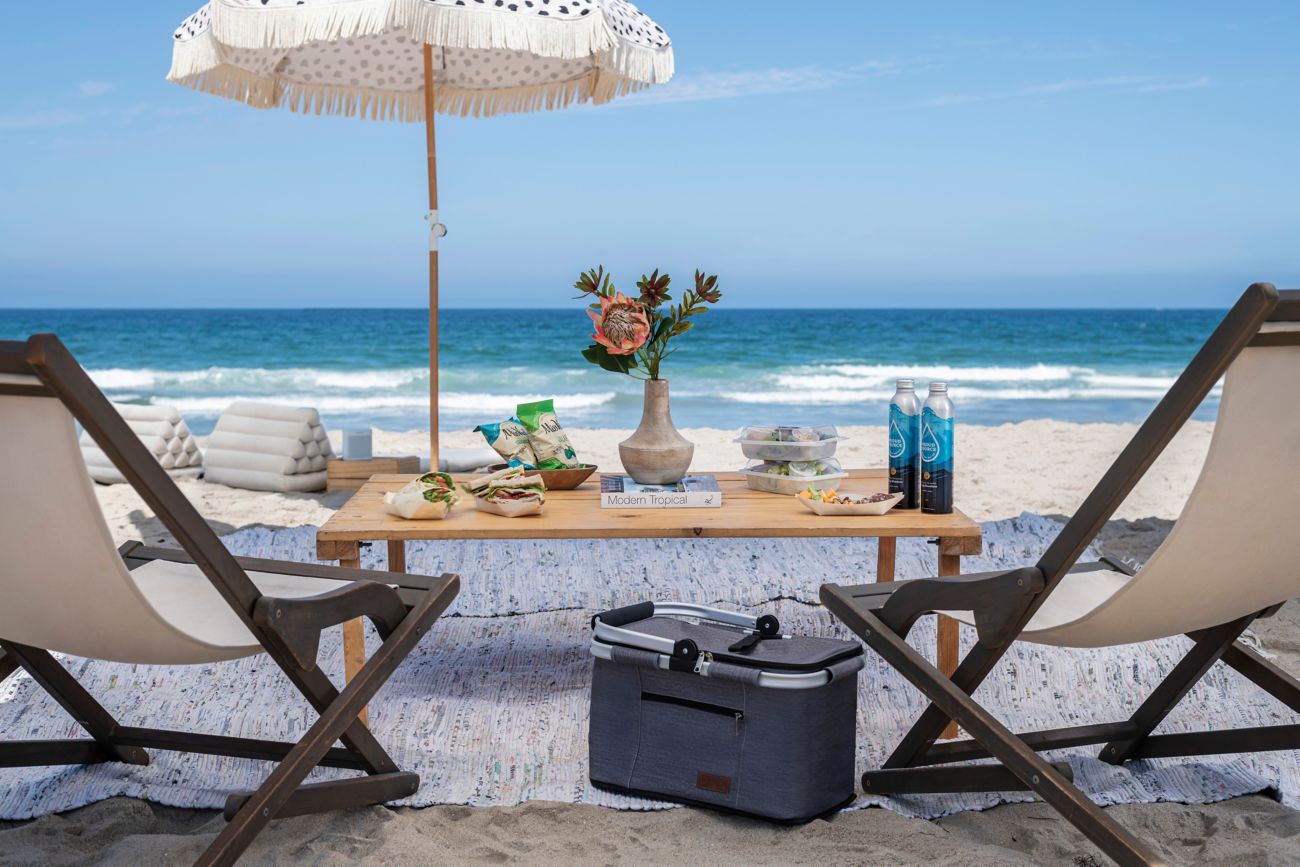 Chairs, umbrella and table with food on the beach