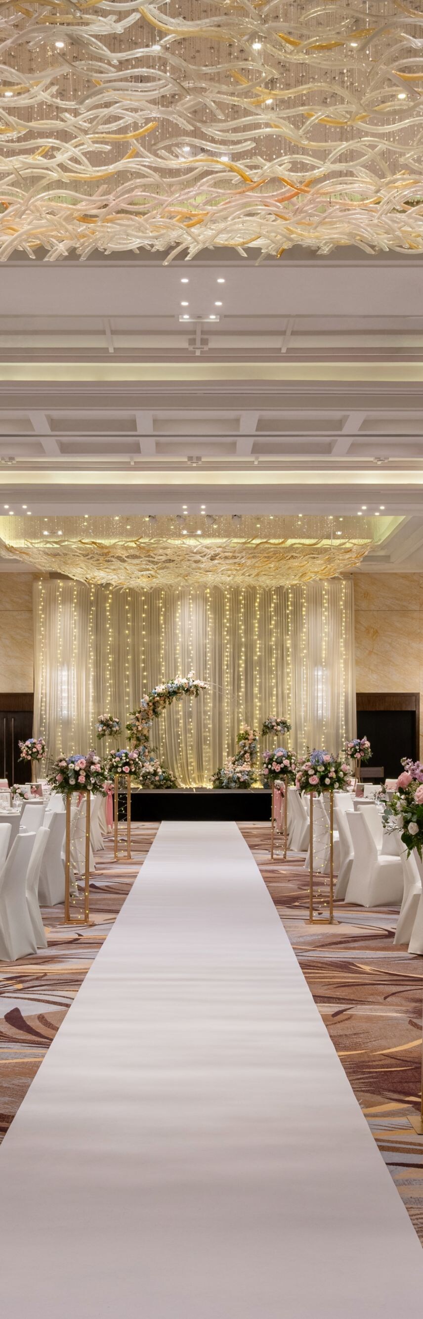 Ballroom wedding setup with runner and tables