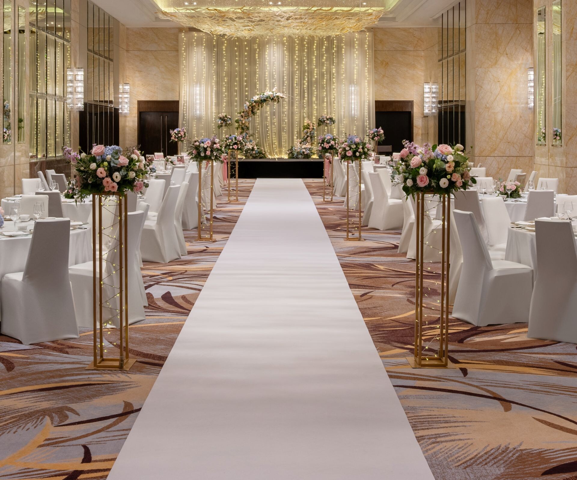 Ballroom wedding setup with runner and tables