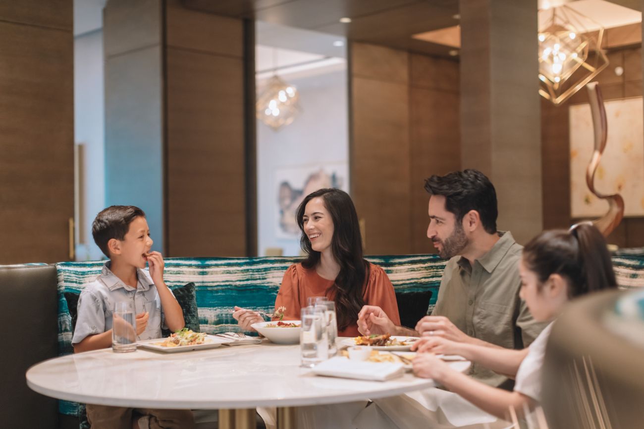Family of four eating in sit down restaurant