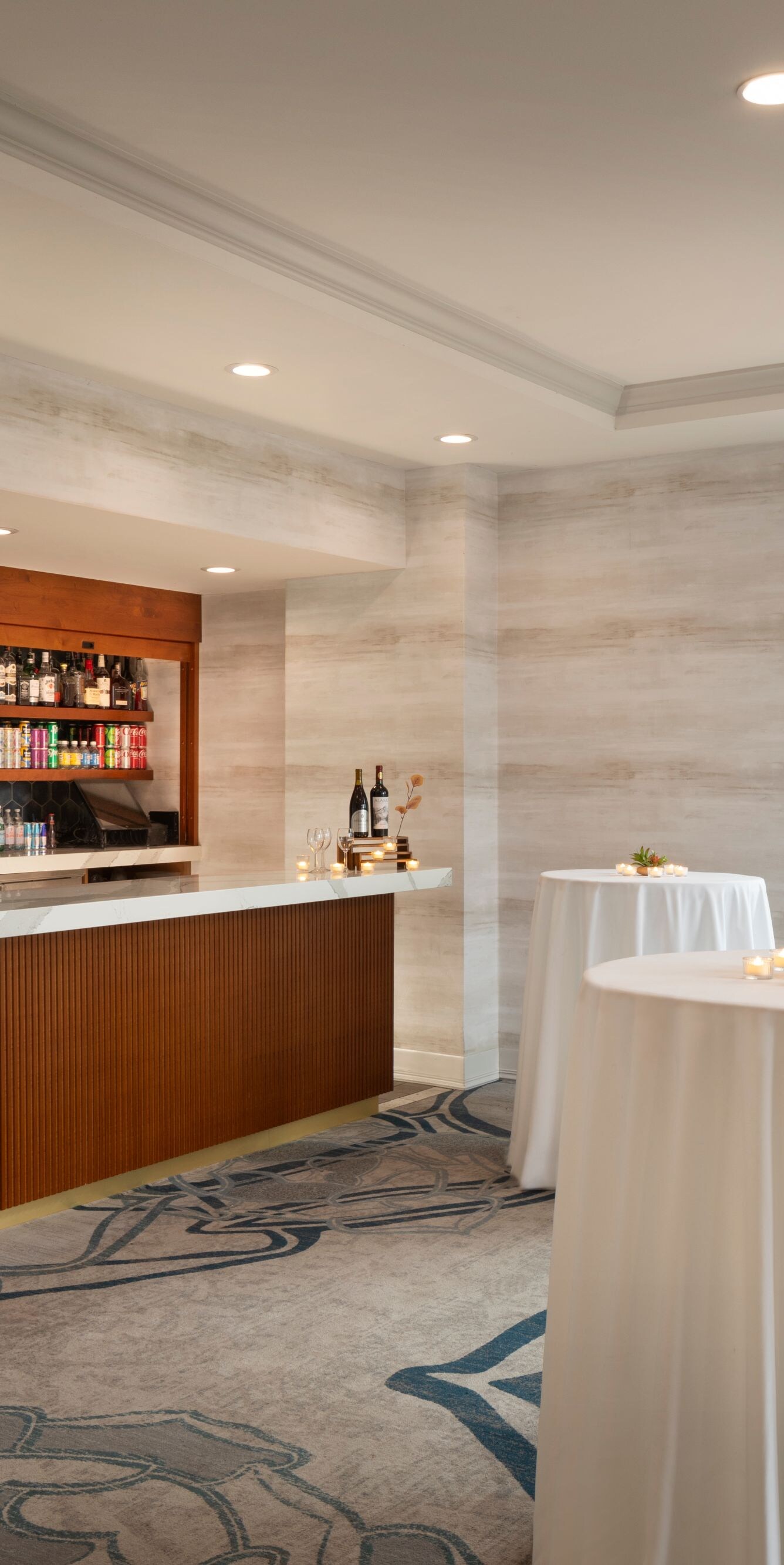 Indoor reception area with bar and cocktail tables