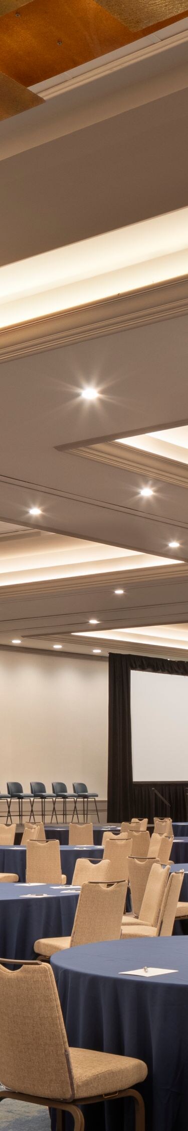Ballroom set with round tables and presentation sc