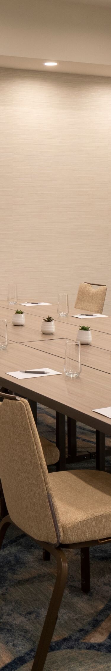 Boardroom with conference table and wall screen