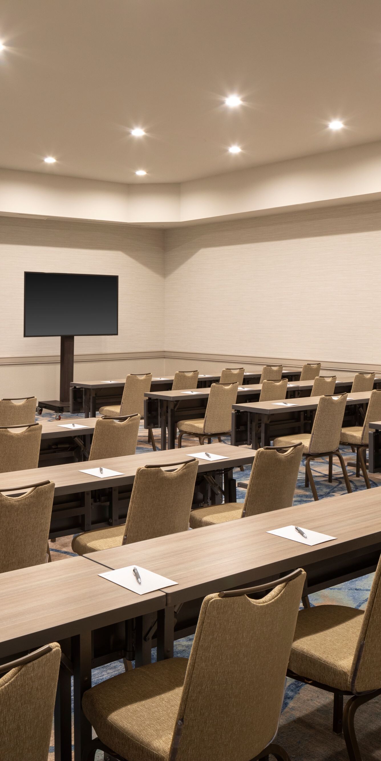 Classroom‑style meeting room with long tables