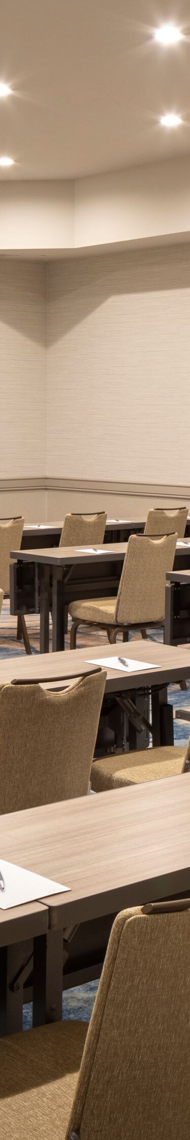 Classroom‑style meeting room with long tables