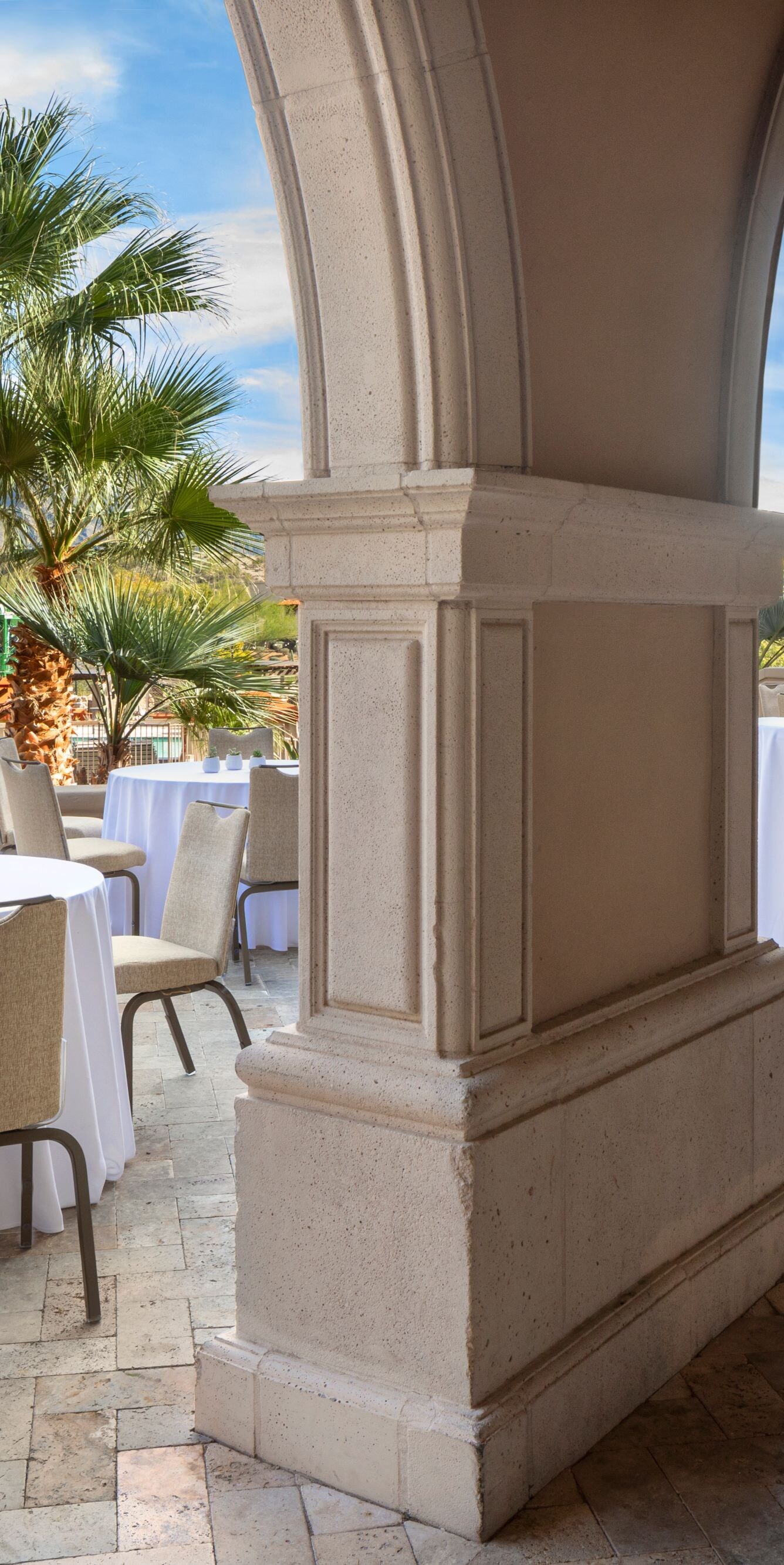 Outdoor terrace with cocktail tables and arches