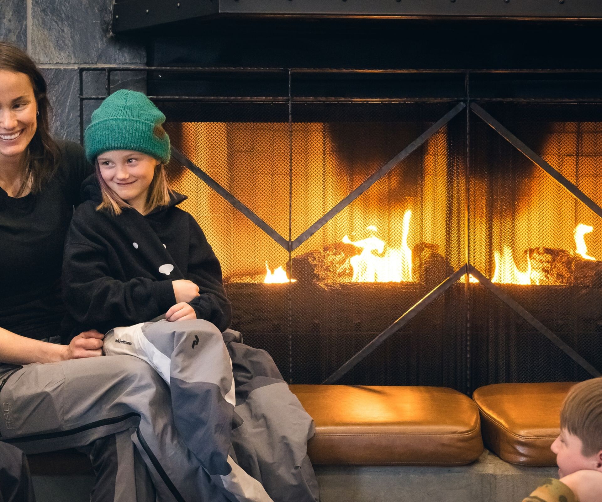 Family enjoying hot chocolate in front of fire