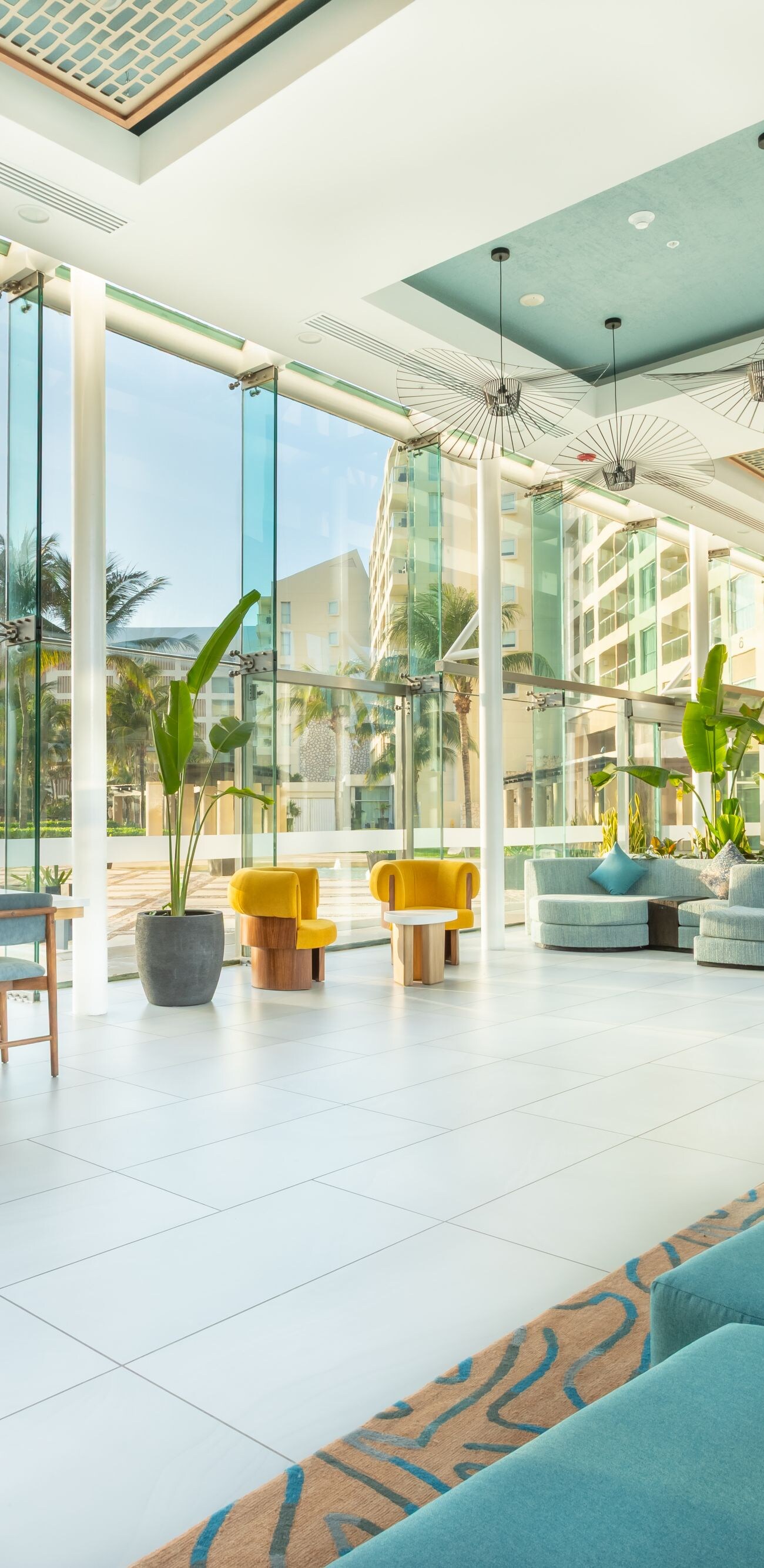Lobby, seating area with view of palm trees, beach