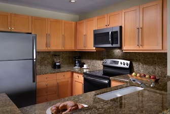 Kitchen with fridge, microwave, oven