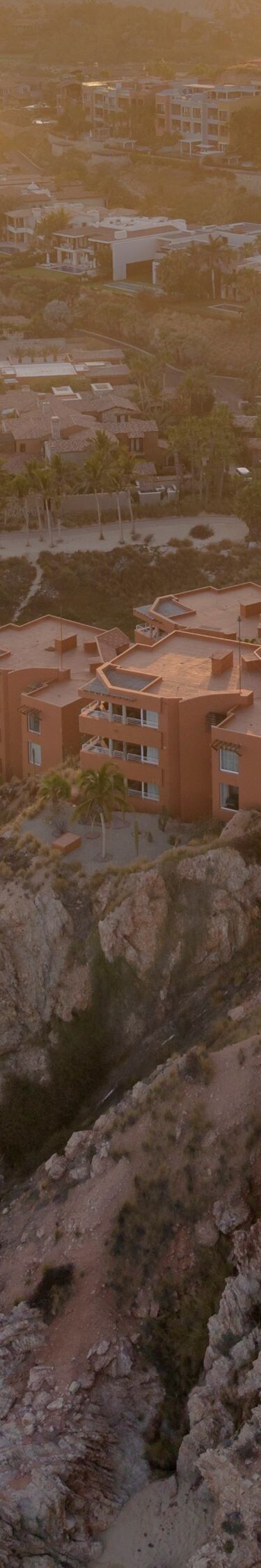 Clifftop resort at sunset above beach and coast