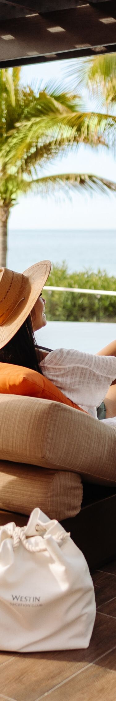 Woman, man drinking in poolside cabana
