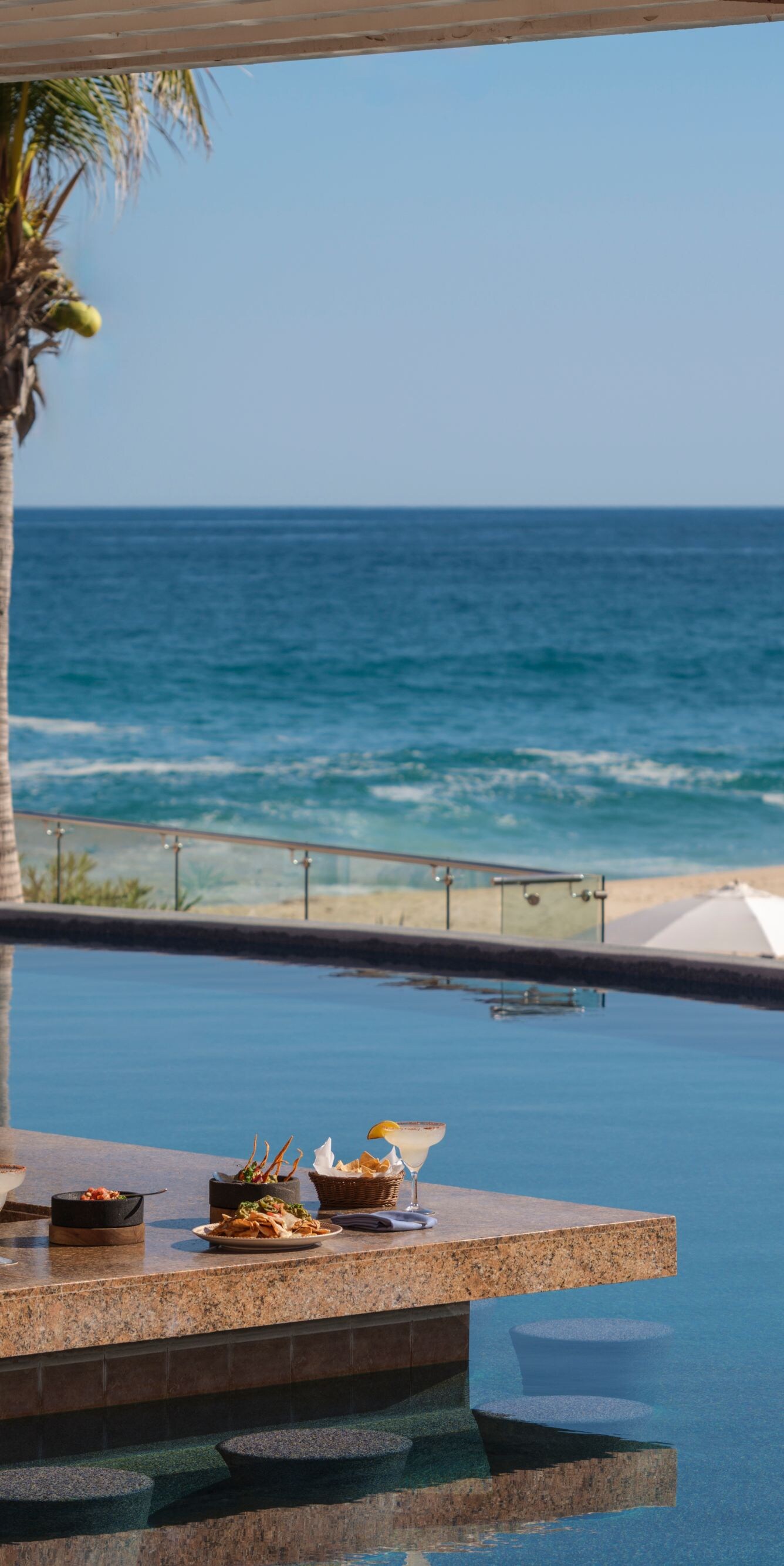 Oceanfront resort pool bar in Los Cabos