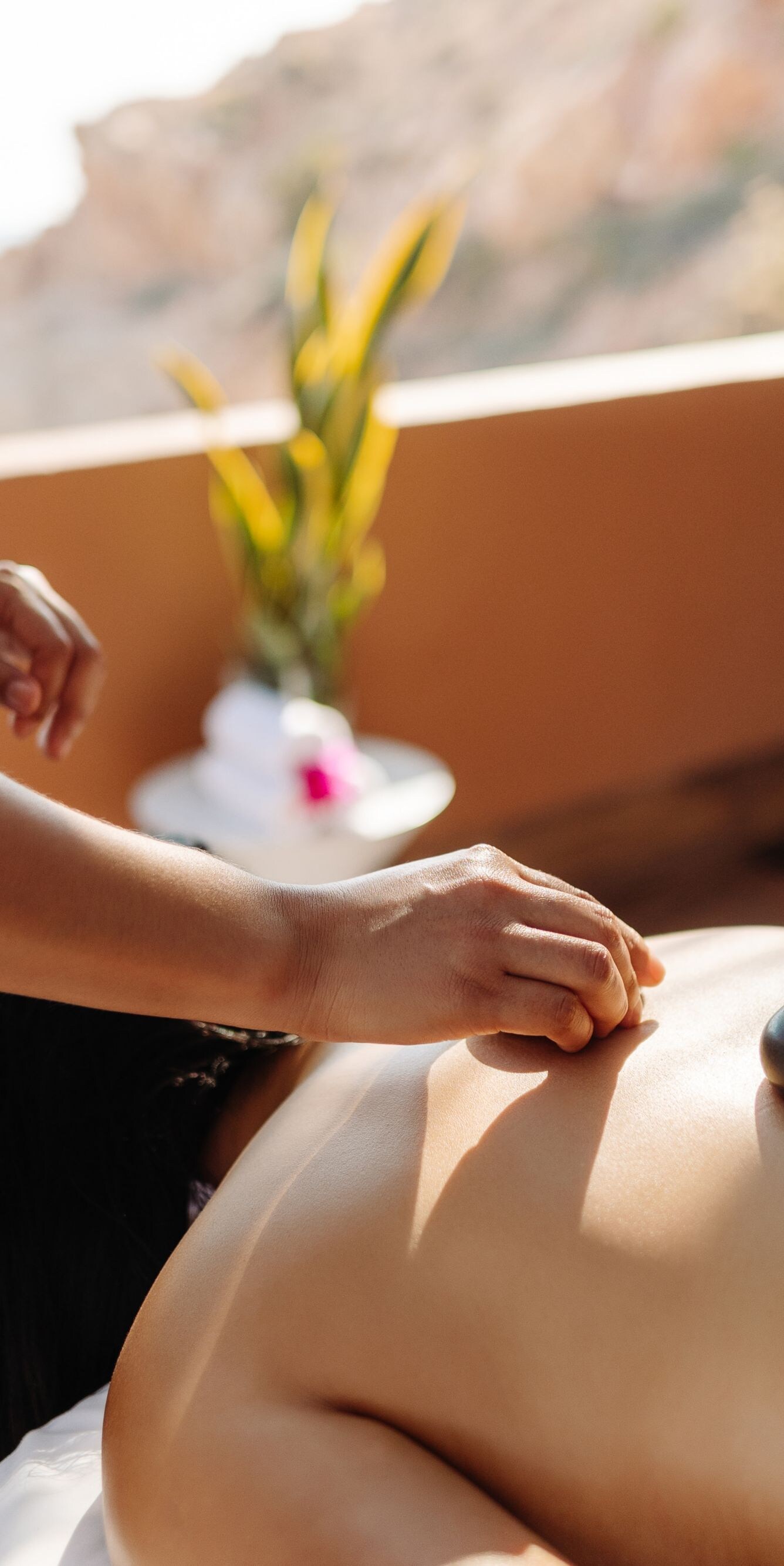 Woman, man receiving massage in outdoor cabana