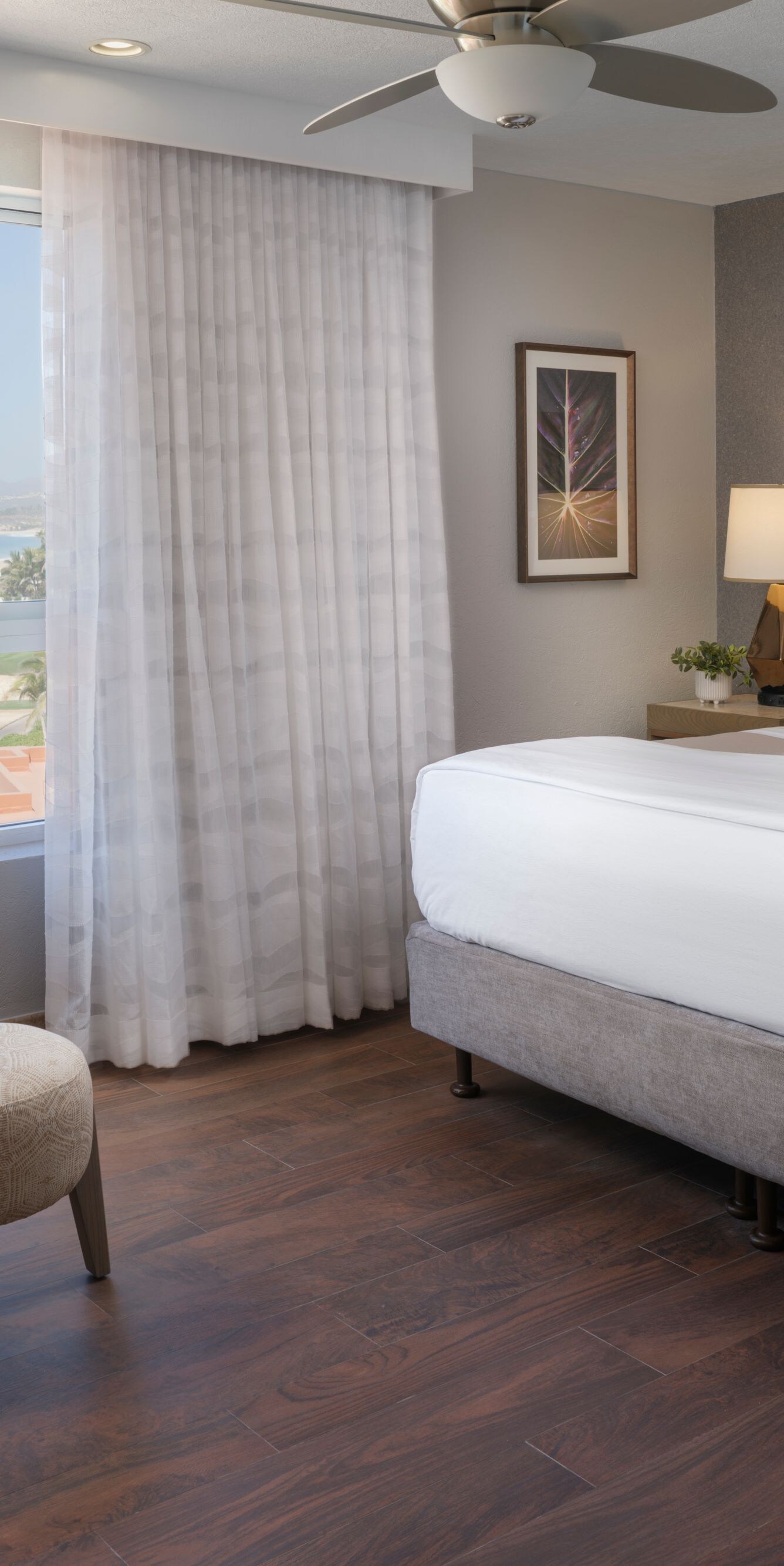 bed with chair and ottoman, ocean view