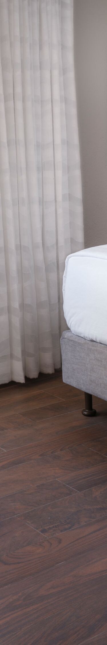bed with chair and ottoman, ocean view