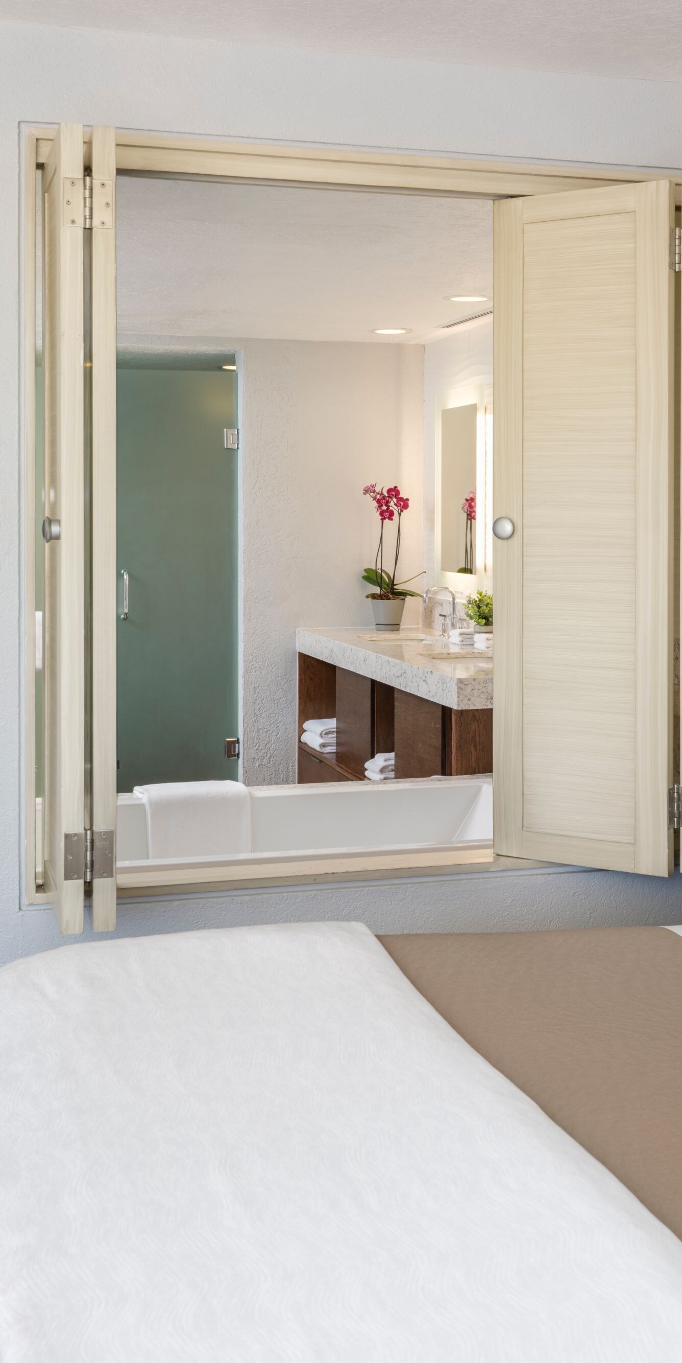 King bed and bathroom with soaking tub
