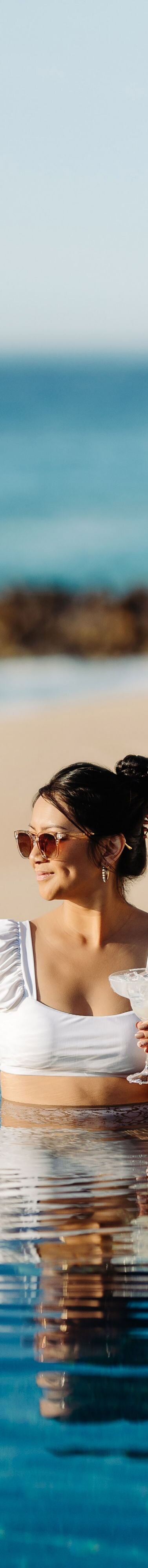 Woman drinking at resort pool in Los Cabos