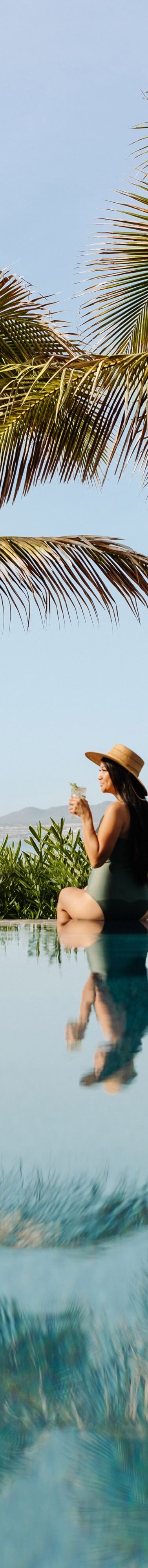 Woman at oceanfront resort pool in Los Cabos