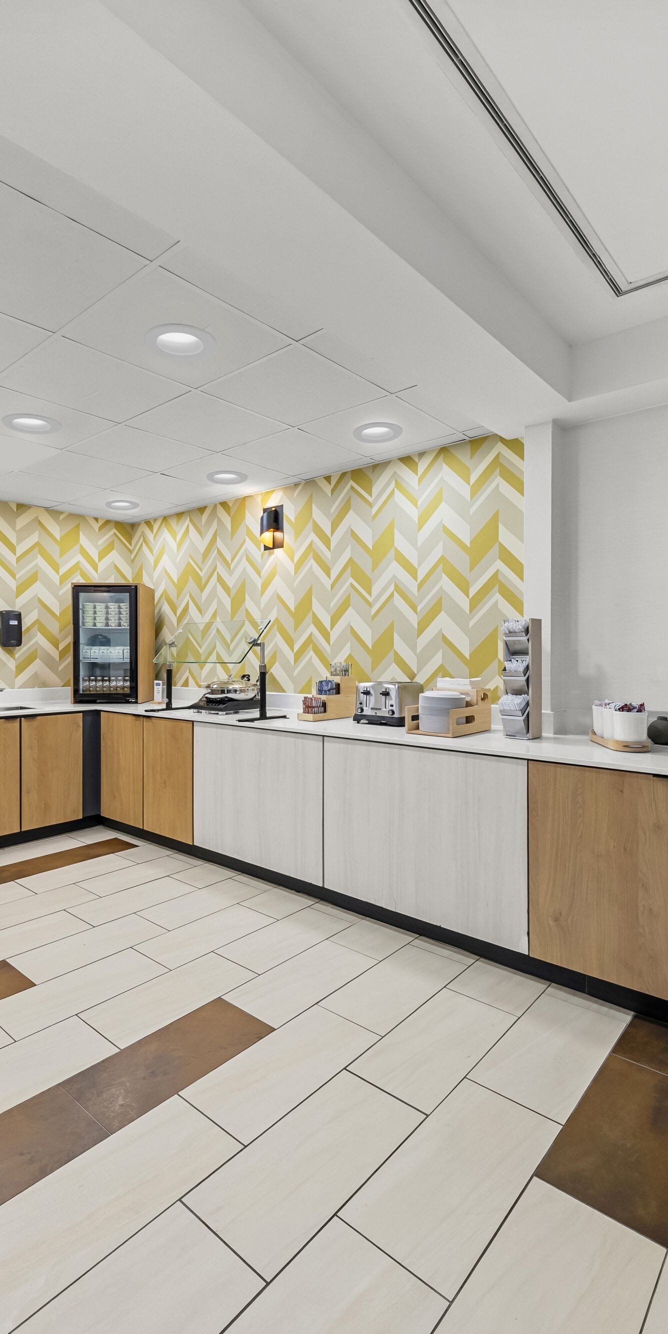 Buffet counter beside patterned accent wall