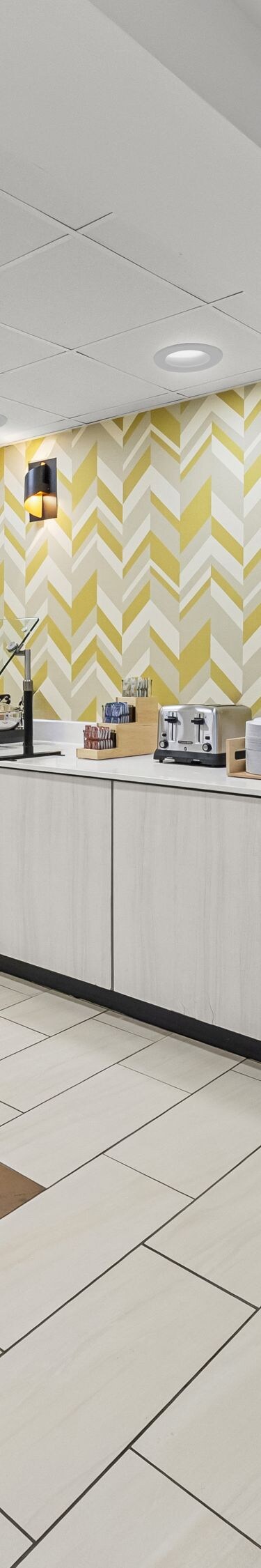 Buffet counter beside patterned accent wall