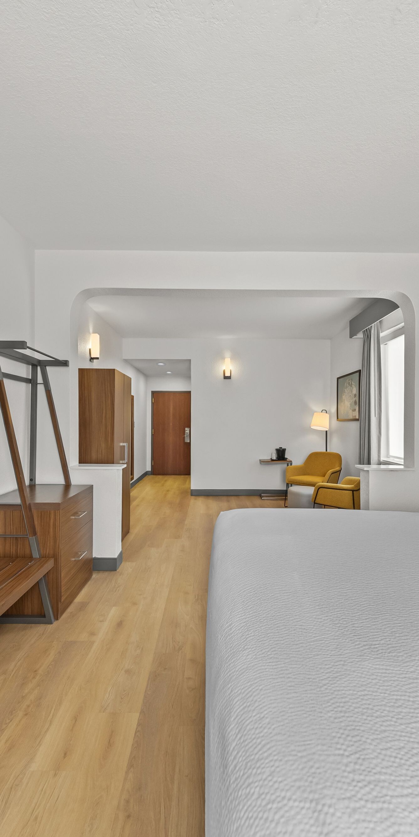King bed with wall-mounted TV and desk