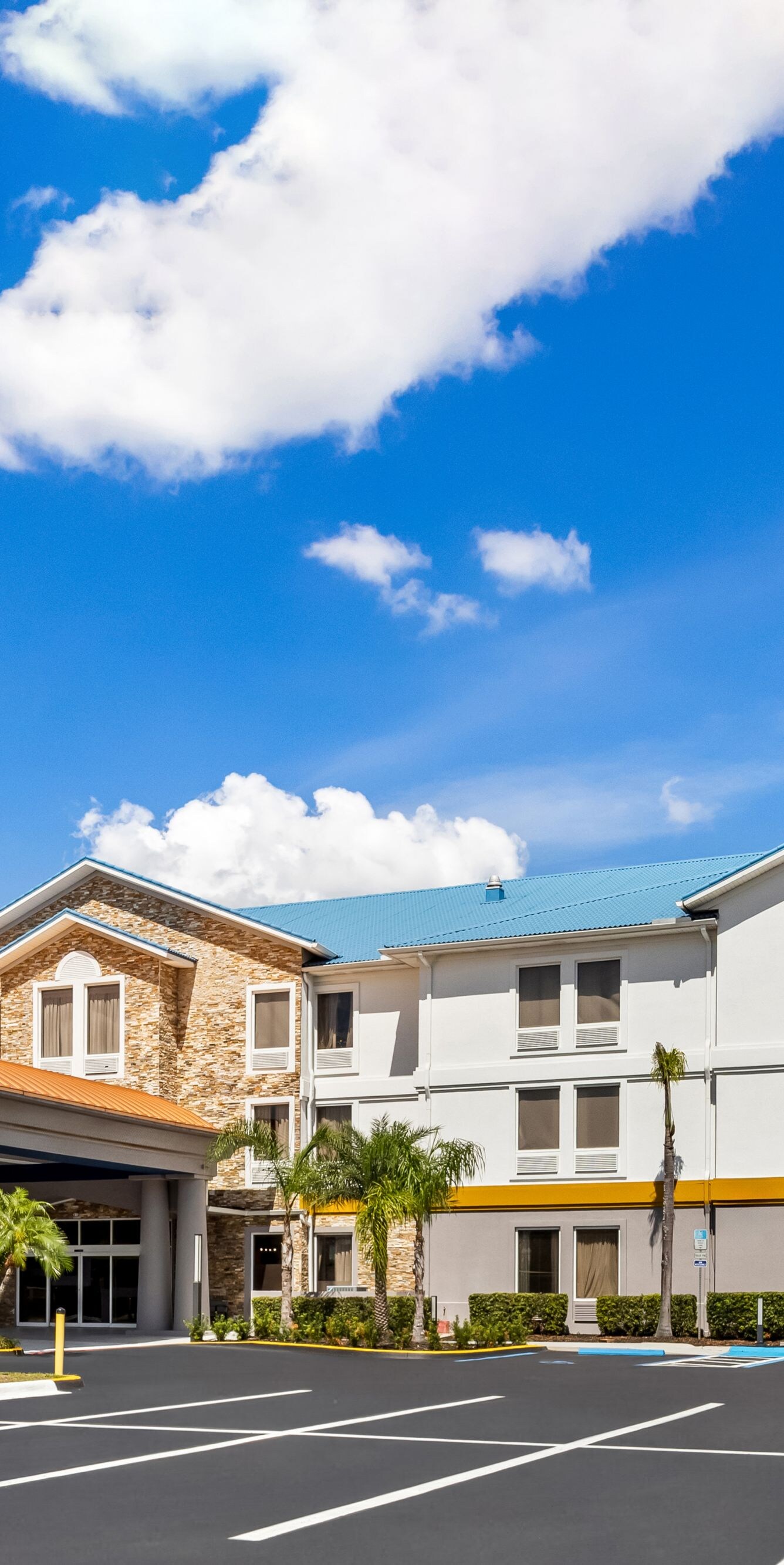 Hotel entrance and parking under blue sky