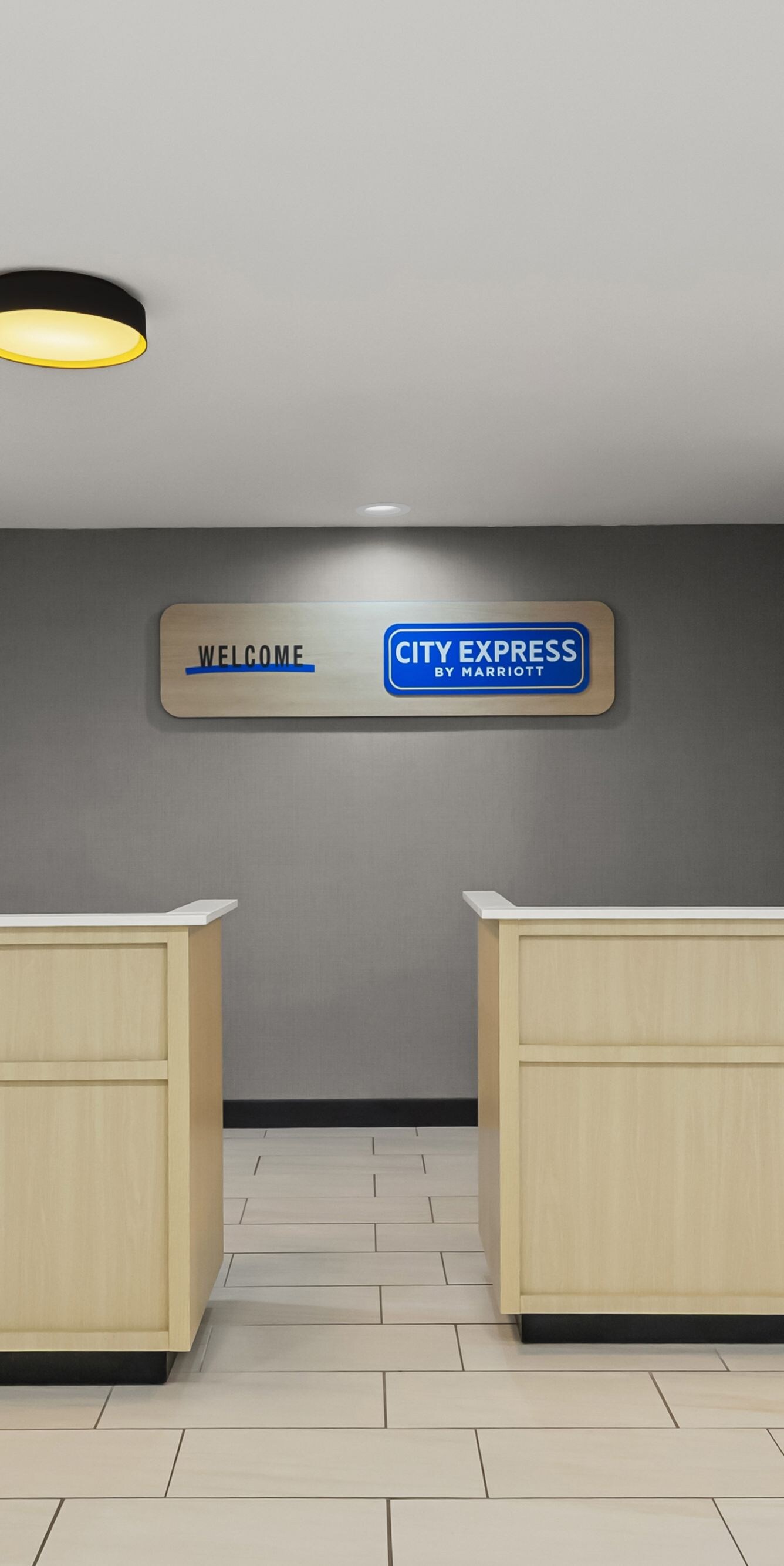 Front desk with City Express welcome sign