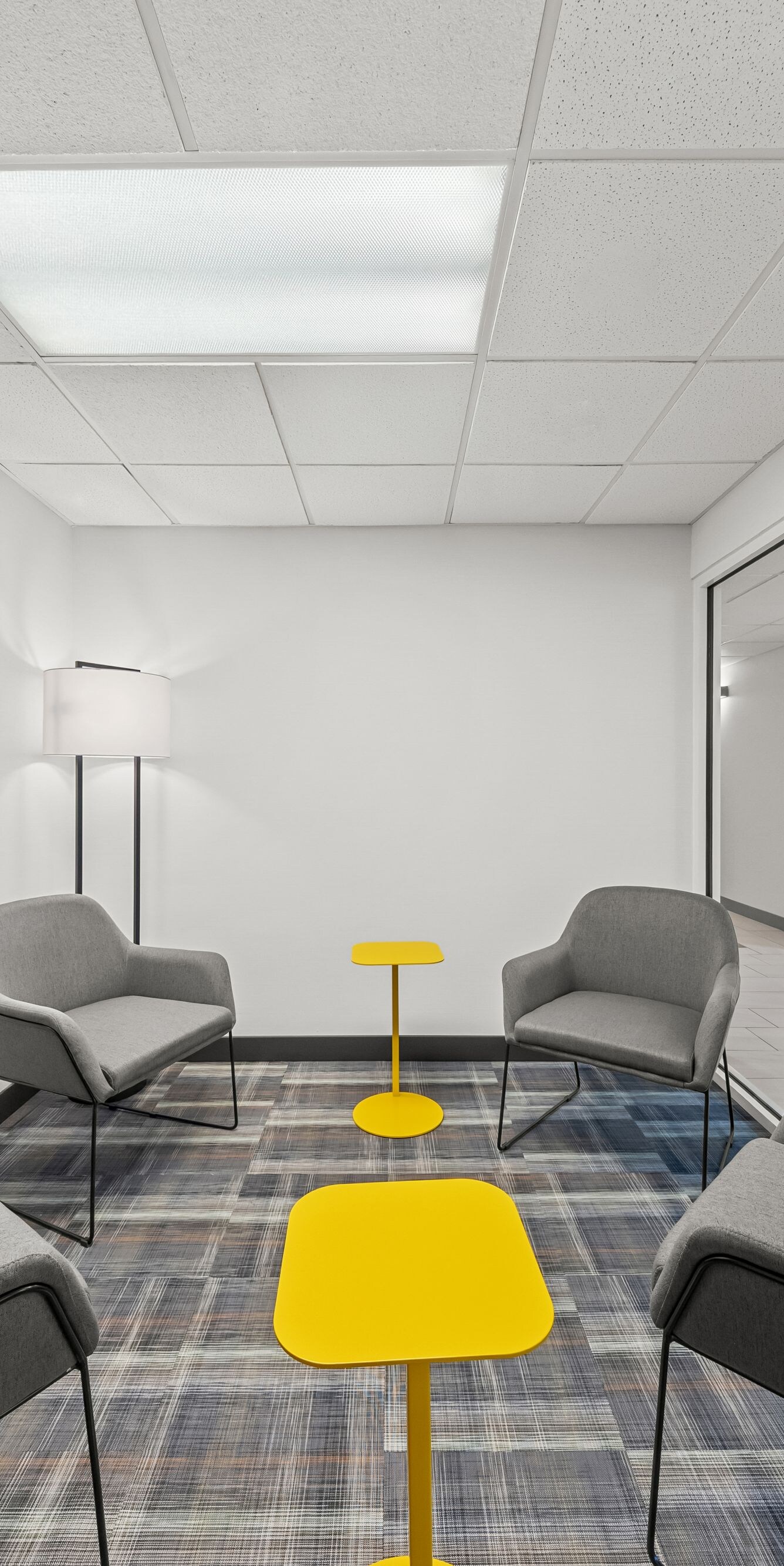 Gray lounge chairs around yellow tables