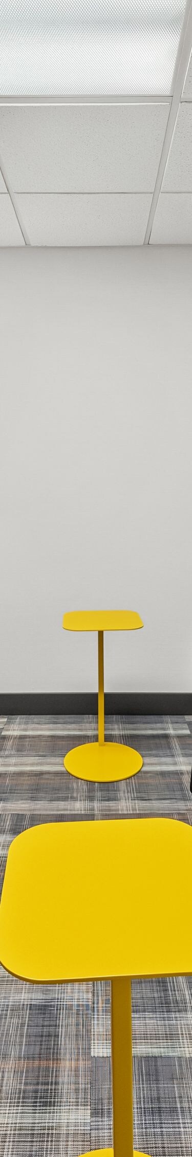 Gray lounge chairs around yellow tables