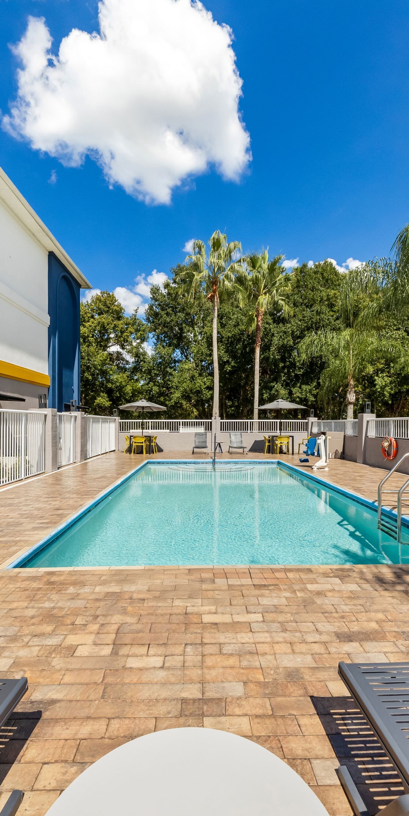 Outdoor pool with loungers and paver deck