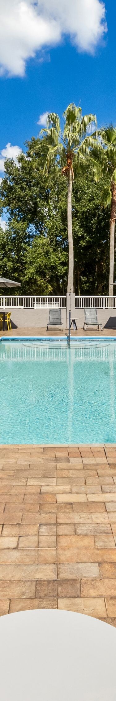 Outdoor pool with loungers and paver deck