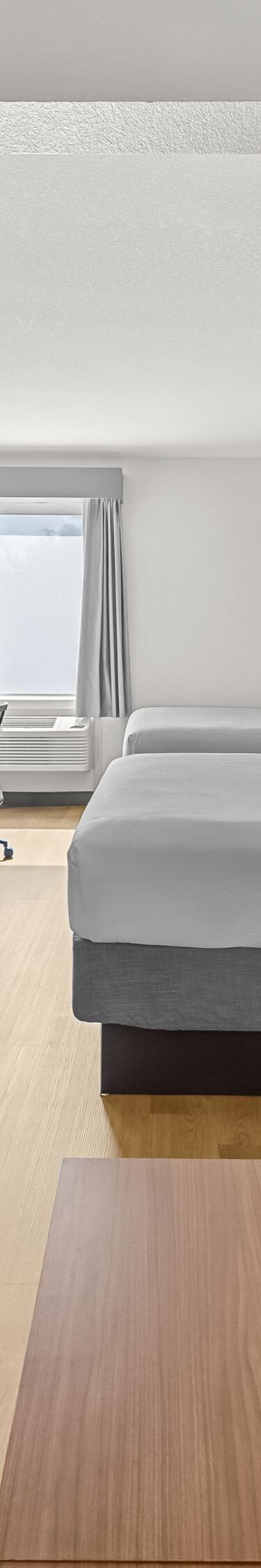 Two queen beds with navy sofa
