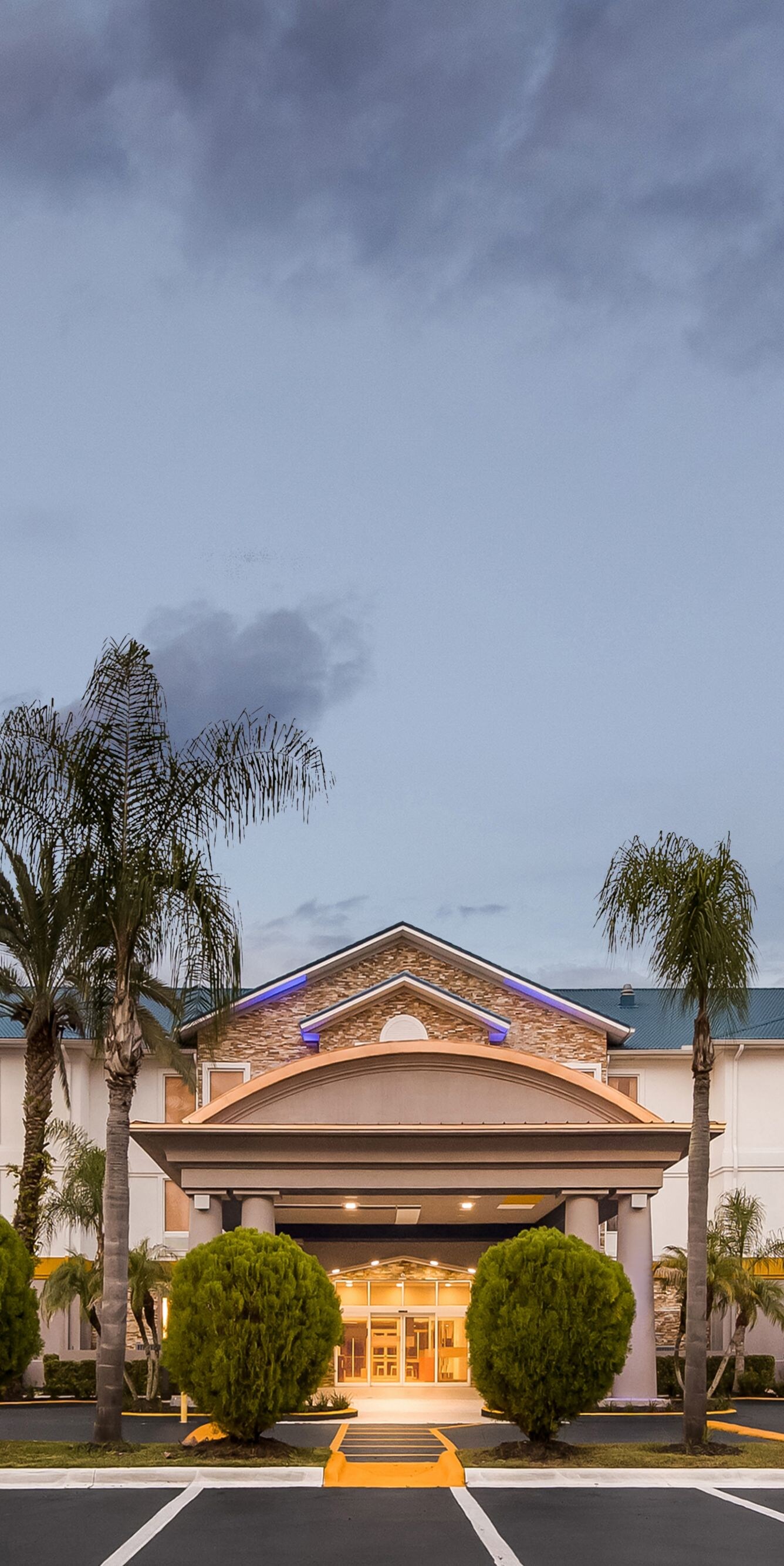 Hotel entrance glowing beneath twilight sky