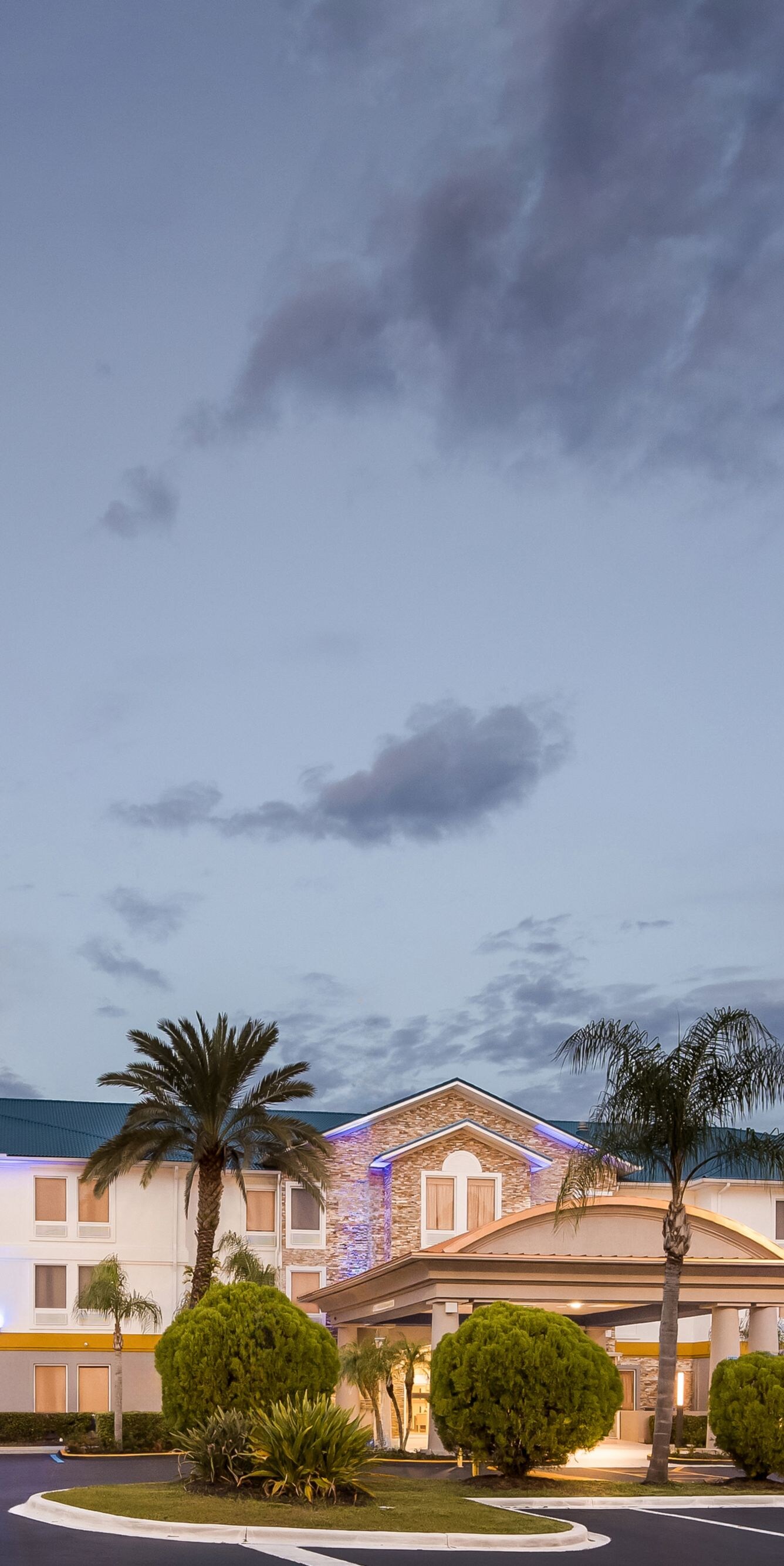 Wide view of hotel exterior at dusk