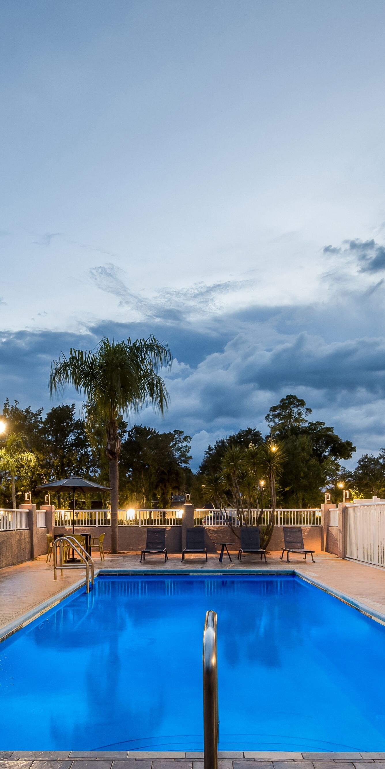 Outdoor pool glowing beneath twilight sky