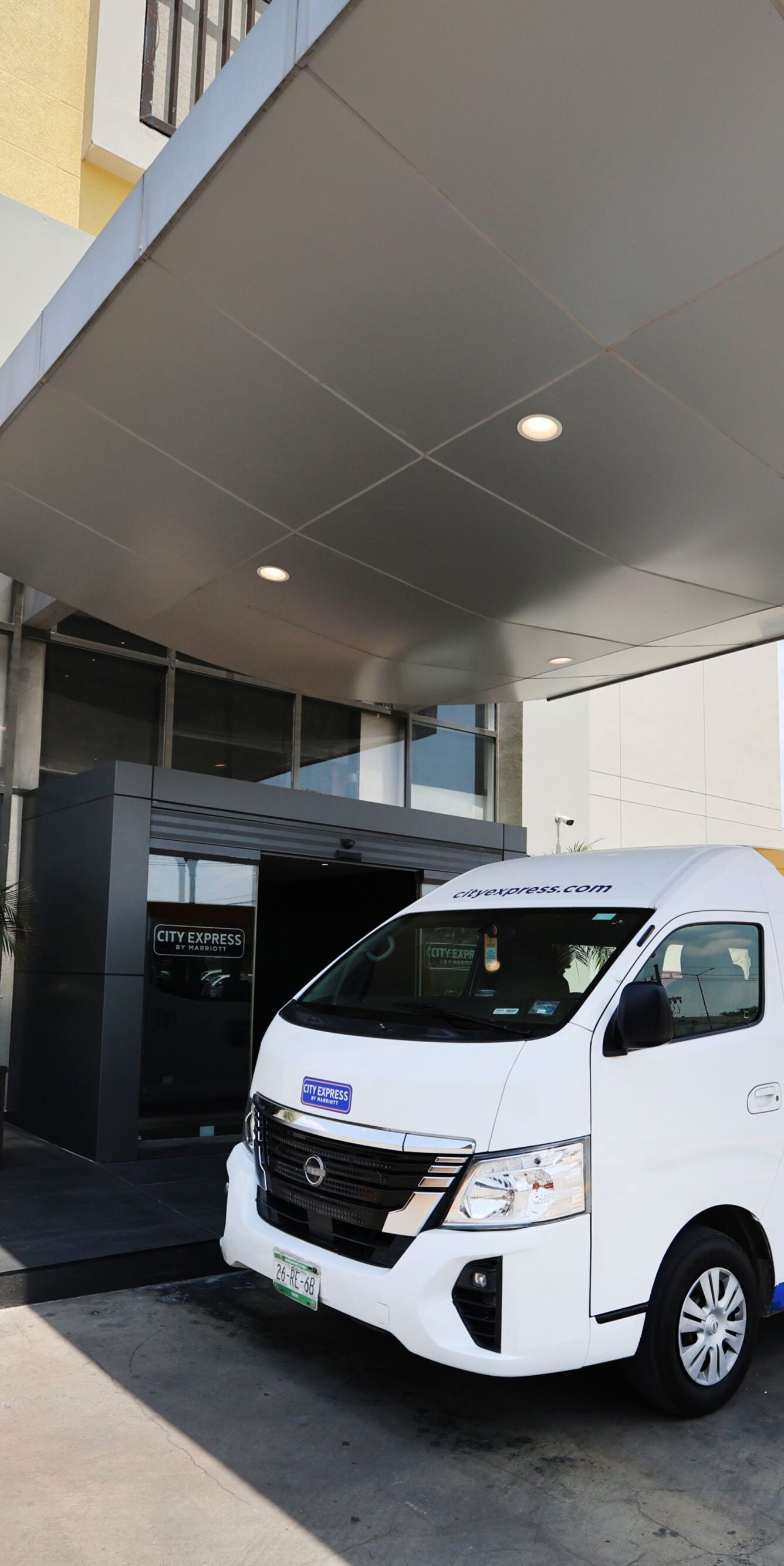 Shuttle van outside exterior of hotel building