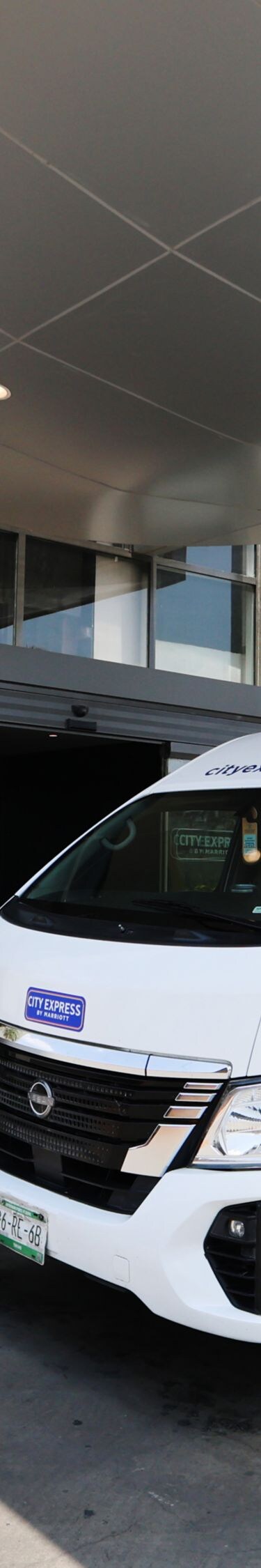 Shuttle van outside exterior of hotel building